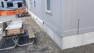 DURASKIRT™ on a manufactured home shown on a sloped lot