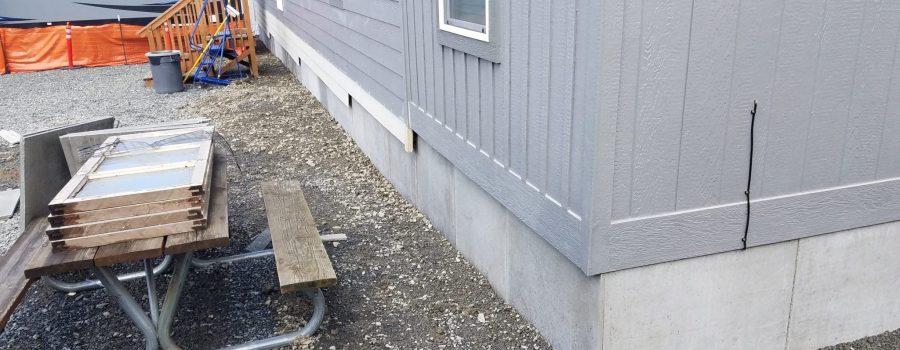 DURASKIRT™ on a manufactured home shown on a sloped lot